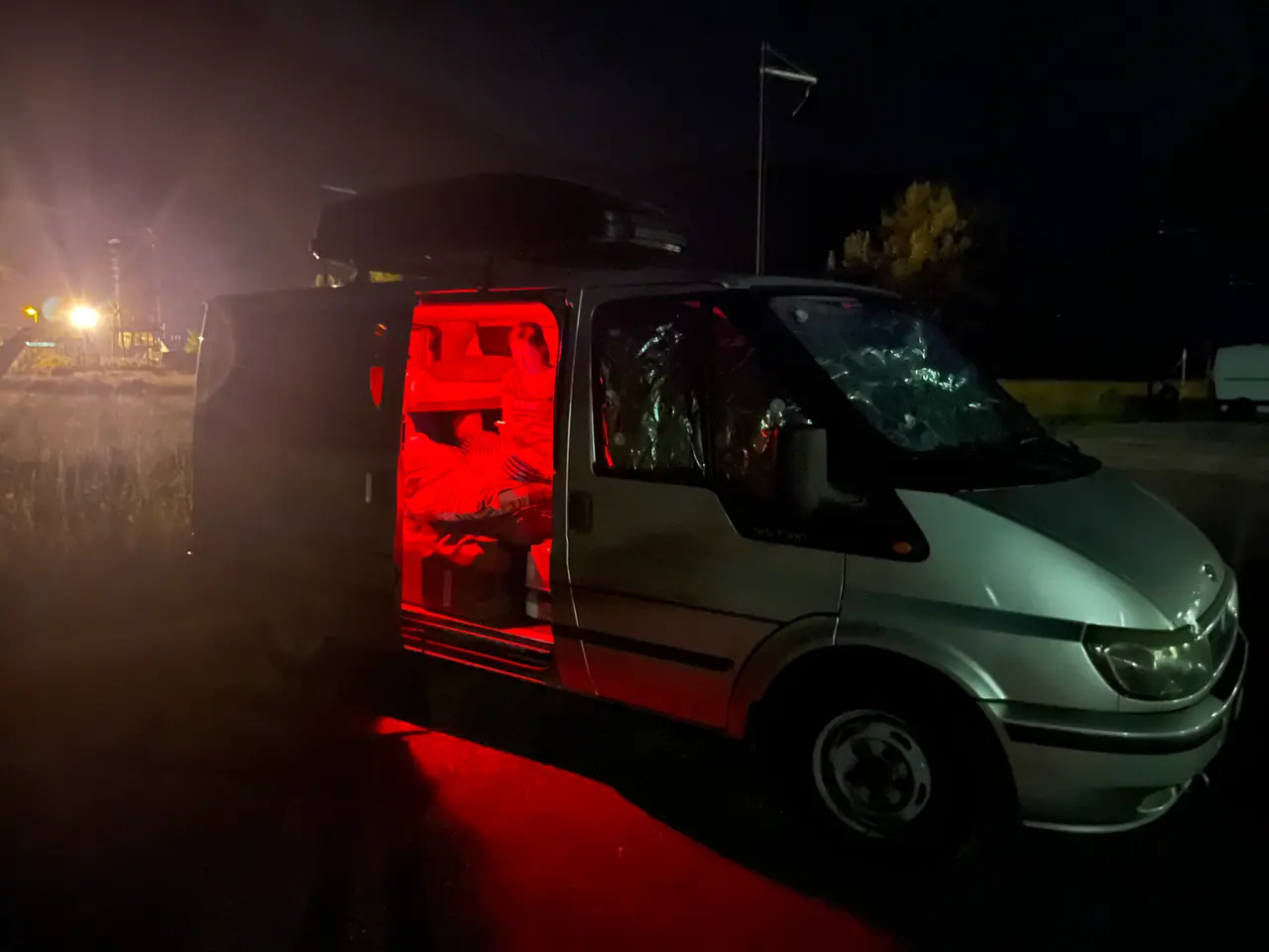 Dodávka s rozsvíceným červeným světlem v noci na parkovišti u Casasoly ve Furlansku