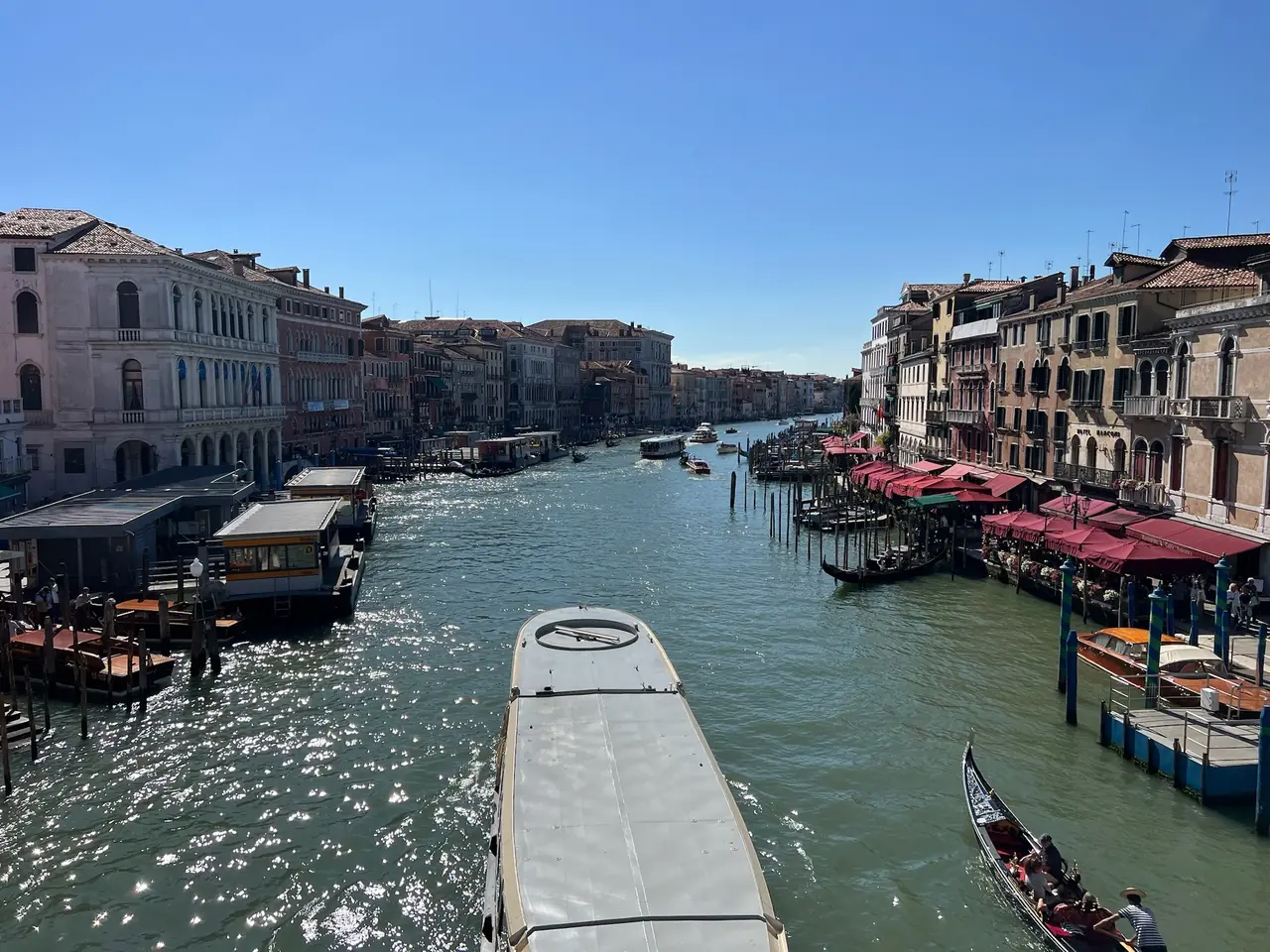 Výhled z mostu Rialto na Canal Grande, lodě a gondoly