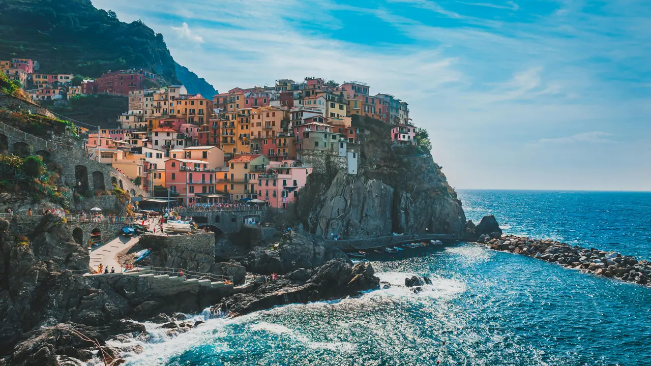 Vibrant houses on a cliff overlooking the ocean in Cinque Terre, Italy. Stunning coastal scenery.